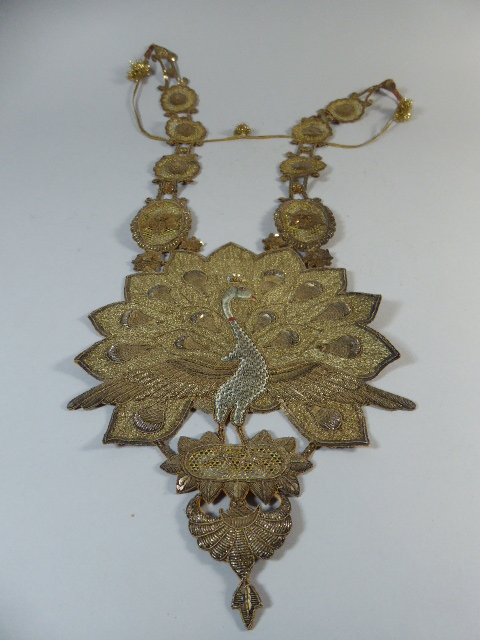 An Indian Ceremonial Chest Piece decorated with Gold and Silver Coloured Wires and Sequins.