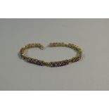 A 9ct Yellow Gold Bracelet Mounted with 35 Amethyst Stones. 12.