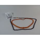 A String of Victorian Orange Beads Together with Garnet Style Glass Bead Necklace having a Good