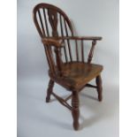 A 19th Century Child's Windsor Arm Chair with Hoop Back and Pierced Splat over an Elm Seat and