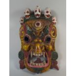 A Tibetan Mahakala Mask Painted in Yellow Green and Red Enamels to Depict the Wrathful Deity