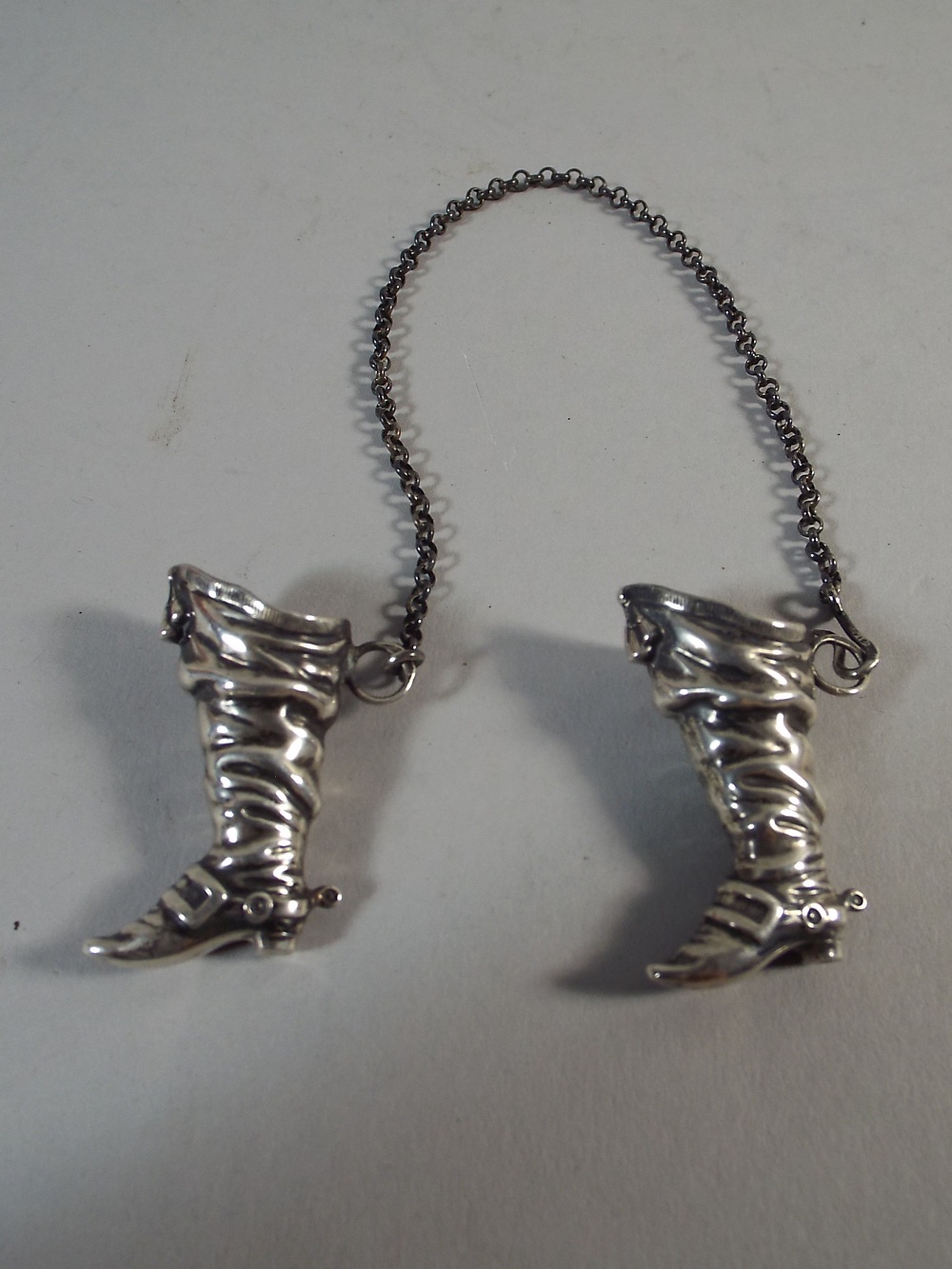 A Pair of Continental Silver Novelty Miniature Cavalry Boots with Spurs. Stamped 900. Each 4cm Tall.