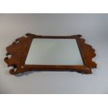 An Early 18th Century George II Wall Mirror with a Fret Cut Walnut Veneered Frame.