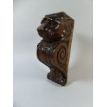 A 19th Century Carved Oak Wall Bracket Corbel with a Lions Head over a Scroll and Shell Motif.
