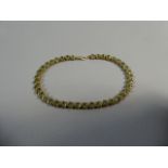 A 9ct Yellow Gold and Peridot Bracelet with 39 Oval Cut Stones. 20cm Long, 11.