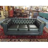 A Button Upholstered Green Leather Chesterfield Three Seater Settee