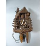 A Carved Black Forest Cuckoo Clock with Clockwork Two Weight Movement.
