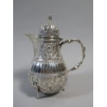 A Late 19th/ Early 20th Century Dutch Silver Hot Water Jug with Embossed Foliate Decoration,