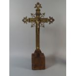 A 19th Century Gilt Brass Crucifix Mounted on an Oak Plinth. 52cm High.