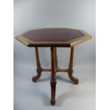 A Good Quality Gillows Tooled Leather Topped Octagonal Table on Reeded Supports with Four Scrolled