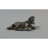 A Miniature Silver Study of a Reclining Foal, Stamped 800. 4.5cm Long. 2cm Tall.