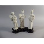 A Set of Three Blanc De Chine Maidens set on Carved Wooden Stand. Each of the Figures Holding a Fan.