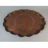 A Beaten Copper Oval Gallery Tray with Incised Dolphin Decoration.