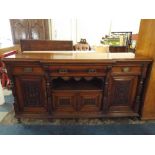 A Late Victorian Breakfront Oak Sideboard with Three Drawers Over Cupboards.