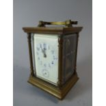 A Cased French Carriage Clock with Tapering Pilaster Supports and White Enamel Dial with Alarm