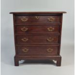 A Small Mahogany Chest of Four Long Drawers with Side Carrying Handles, on Bracket Feet.