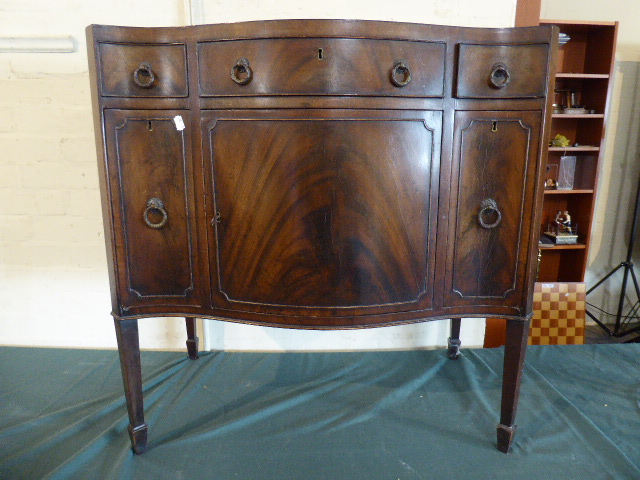 An Edwardian Mahogany Serpentine Fronted Side Cabinet with One Long and Two Short Drawers over Two