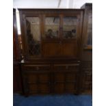 An Oak Lounge Unit with Leaded Glazed Top Cupboard Base and Two Drawers