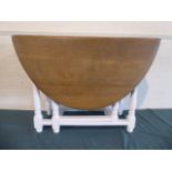 An Oak Drop Leaf Oval Top Dining Table with White Painted Gate Leg Base,