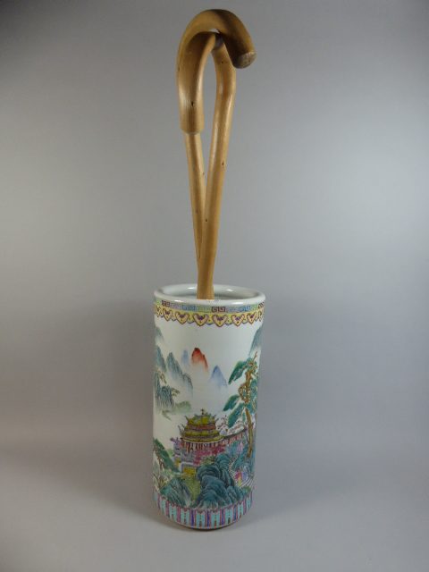 An Oriental Ceramic Stick Stand Containing Two Walking Sticks