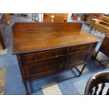 An Edwardian Oak Side Board with Two Drawers Over Cupboard