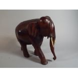 A Carved Wooden Study of an Elephant, One Tusk Glued,