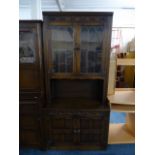 An Oak Leaded Glazed Book Case with Cupboard Base