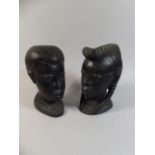 A Pair of Carved Wooden Ebonised African Busts of Male and Female.