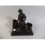 A Spelter Figure of Seated Cobbler Holding Shoe.