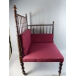 An Unusual Late Victorian Rosewood Spindle Back Corner Seat with Later Cushions on Brass Casters.