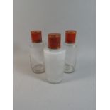 A Set of Three Chemists Bottles with Tolware Cylindrical Lids,