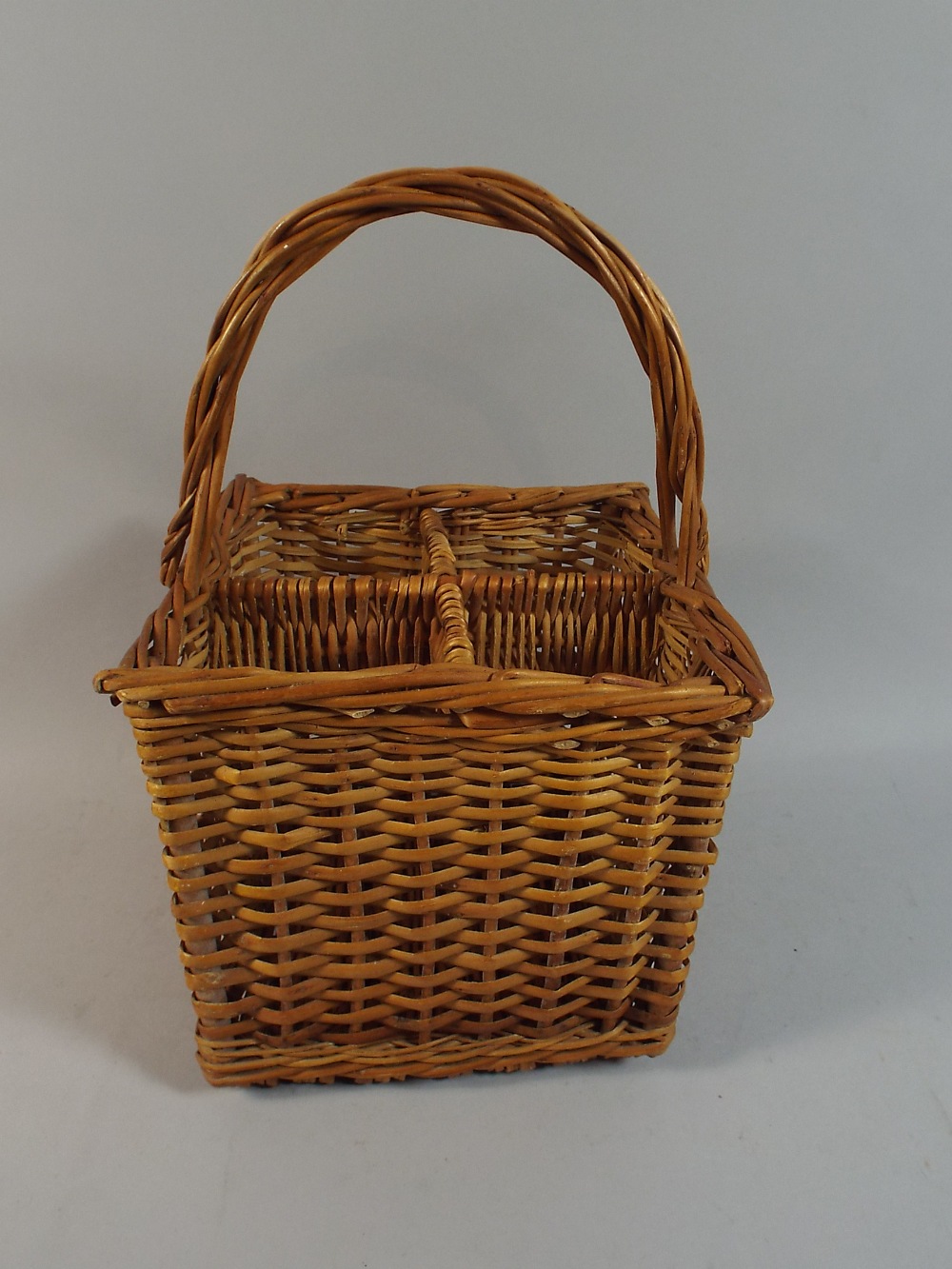 A Wicker Four Bottle Carrying Basket.