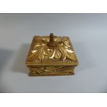 A Gilt Decorated Square Box with Moulded Decoration,