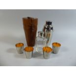 A Leather Cased Silver Plated Cocktail Shaker with Inner Glass Decanter, Four Graduated Cups,