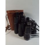 A Pair of Leather Cased Denhil Binoculars 20x50 Together with a Pair of Greenkat and a Pair of