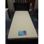 A Single Bed with Breasley Mattress and Leather Headboard