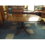 A Mahogany Drop Leaf Oval Top Single Pedestal Dining Table