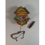 A Decorated Wall Hanging Cuckoo Clock with Weight but Missing Pendulum