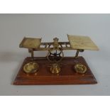 A Set of Brass Postage Scales and Weights Set on Wooden Plinth,