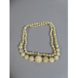 An Edwardian String of Graduated Mother of Pearl Beads, Largest 1.5cm Diameter.