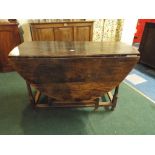 An Early 19th Century Oak Gate Leg Drop Leaf Dining Table with Oval Top and Turned Supports.