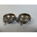 A Pair of Victorian Silver Salts, Embossed Floral Decoration and a Tripod Styled Hoof Feet.