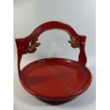 A Chinese Red Lacquered Wooden Circular Tray with Carved and Pierced Fish Motif to Hooped Handle.