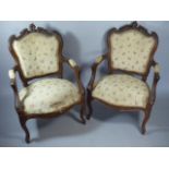 A Pair of French Walnut Framed Salon Armchairs with Carved Top Rails and Cabriole Front Legs.