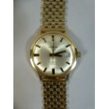 A Gents 9ct Gold Wrist Watch with Gold Strap. Manis Automatic with Calendar.