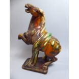 An Antique Weathered Chinese Pottery Figure of a Tang Dynasty Horse.