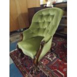 A Victorian Mahogany Framed Button Upholstered Ladies Armchair on Scrolled Cabriole Front Legs.