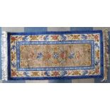 A Modern Woven Silk Patterned Rug Decorated with Blue Birds and Flowers on Blue and Beige Ground.