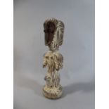 A 19th Century African Carved Wood Fetish Figure with a White Clay Wash, Lega People,