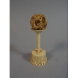 A 19th Century Ivory Four layer Puzzle Ball on Turned Ivory Stand. 10cm High.